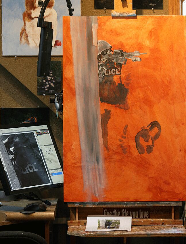 Artist workspace with orange canvas and reference monitor