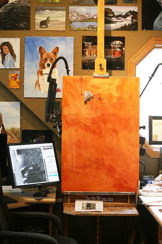 Artist studio with large orange canvas
