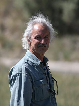 Smiling older man with white hair outdoors