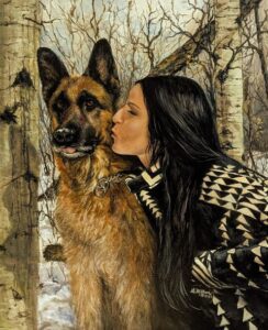 Woman lovingly kisses her German Shepherd in a snowy forest.